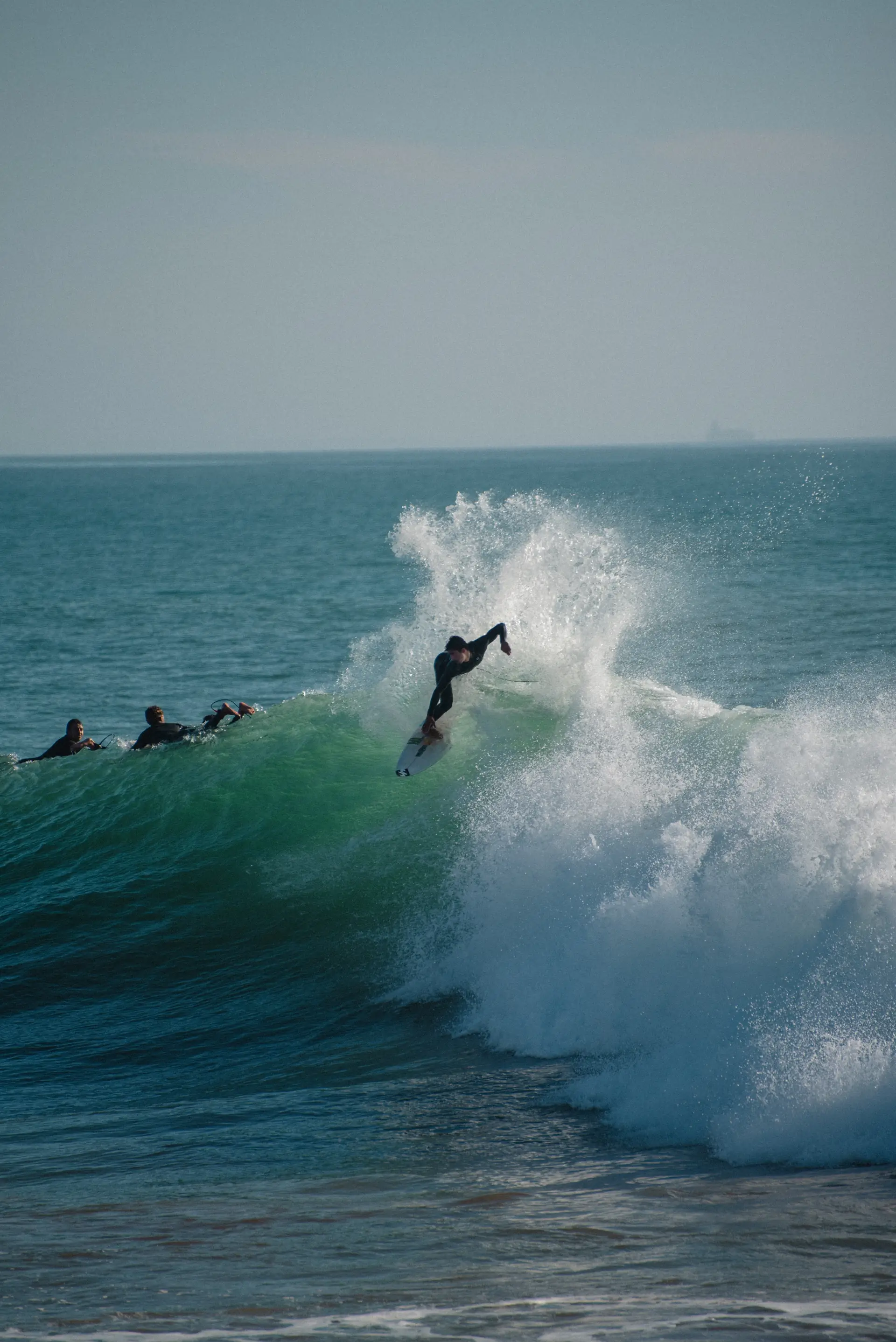 Surfer dropping into a green wave near Taghazout and Tamraght, Morocco